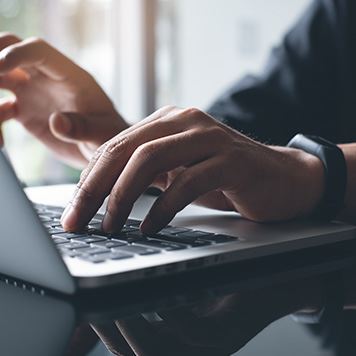person typing on laptop